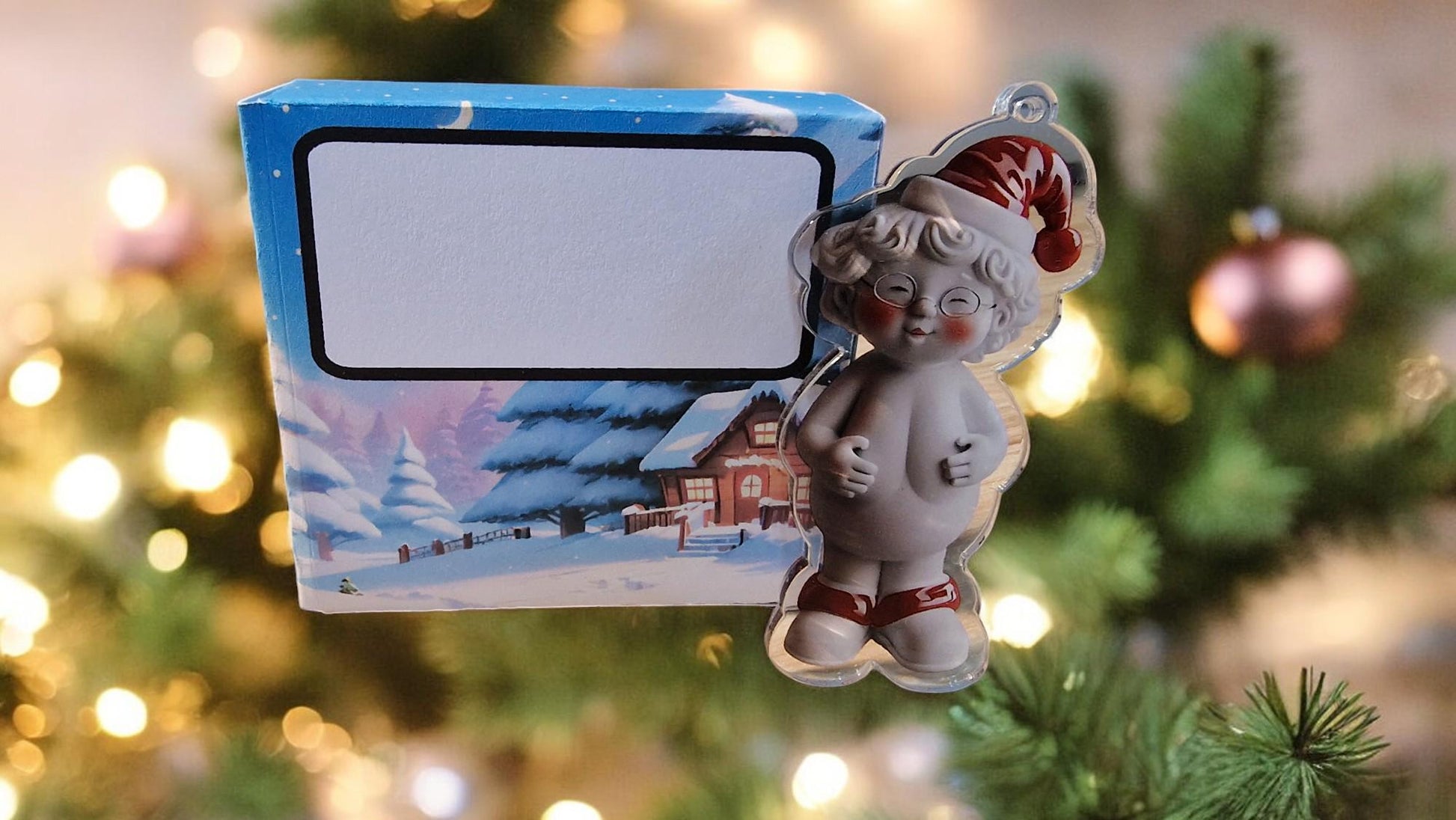 Acrylic Naked Santa and Mrs Claus funny Christmas tree ornaments in a gift box, displayed as cheeky festive decorations.