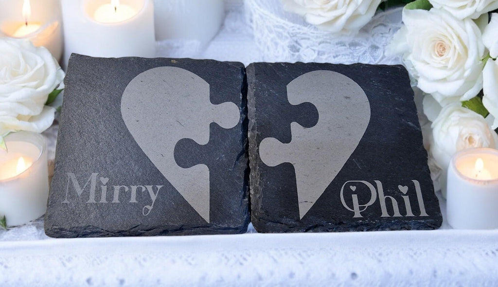 Set of two personalised slate jigsaw heart coasters with engraved names, packaged in a custom gift box, ideal for weddings, Valentine’s Day, or anniversaries.