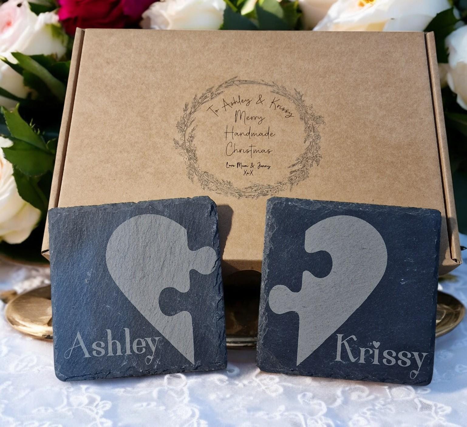 Set of two personalised slate jigsaw heart coasters with engraved names, packaged in a custom gift box, ideal for weddings, Valentine’s Day, or anniversaries.