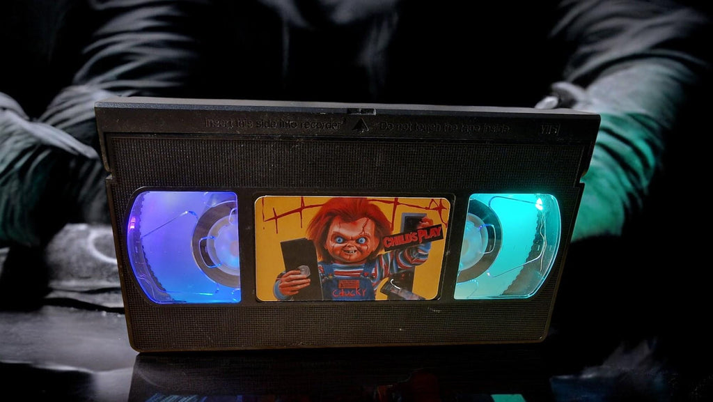 Upcycled Chucky VHS table lamp with flashing light modes, shown as a unique horror fan collectible and movie-themed decor.