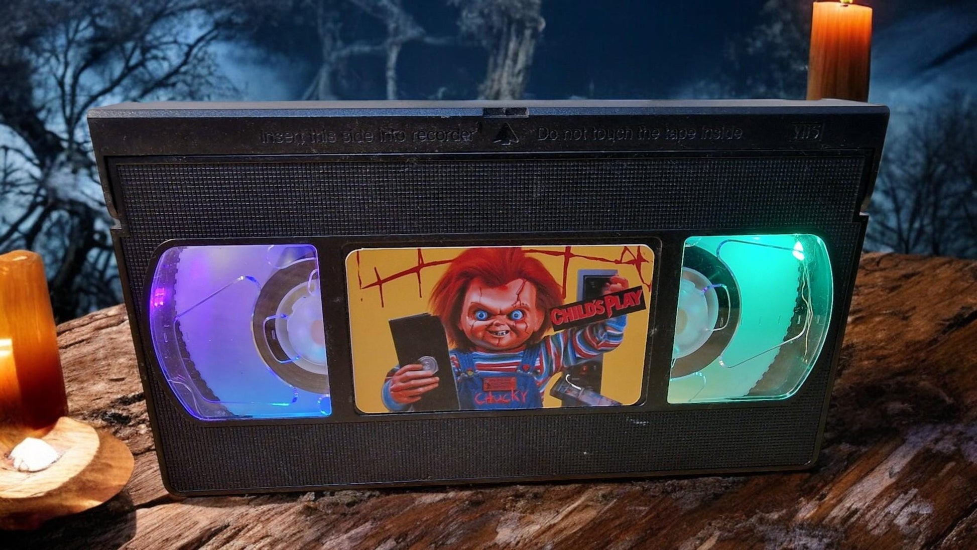 Upcycled Chucky VHS table lamp with flashing light modes, shown as a unique horror fan collectible and movie-themed decor.