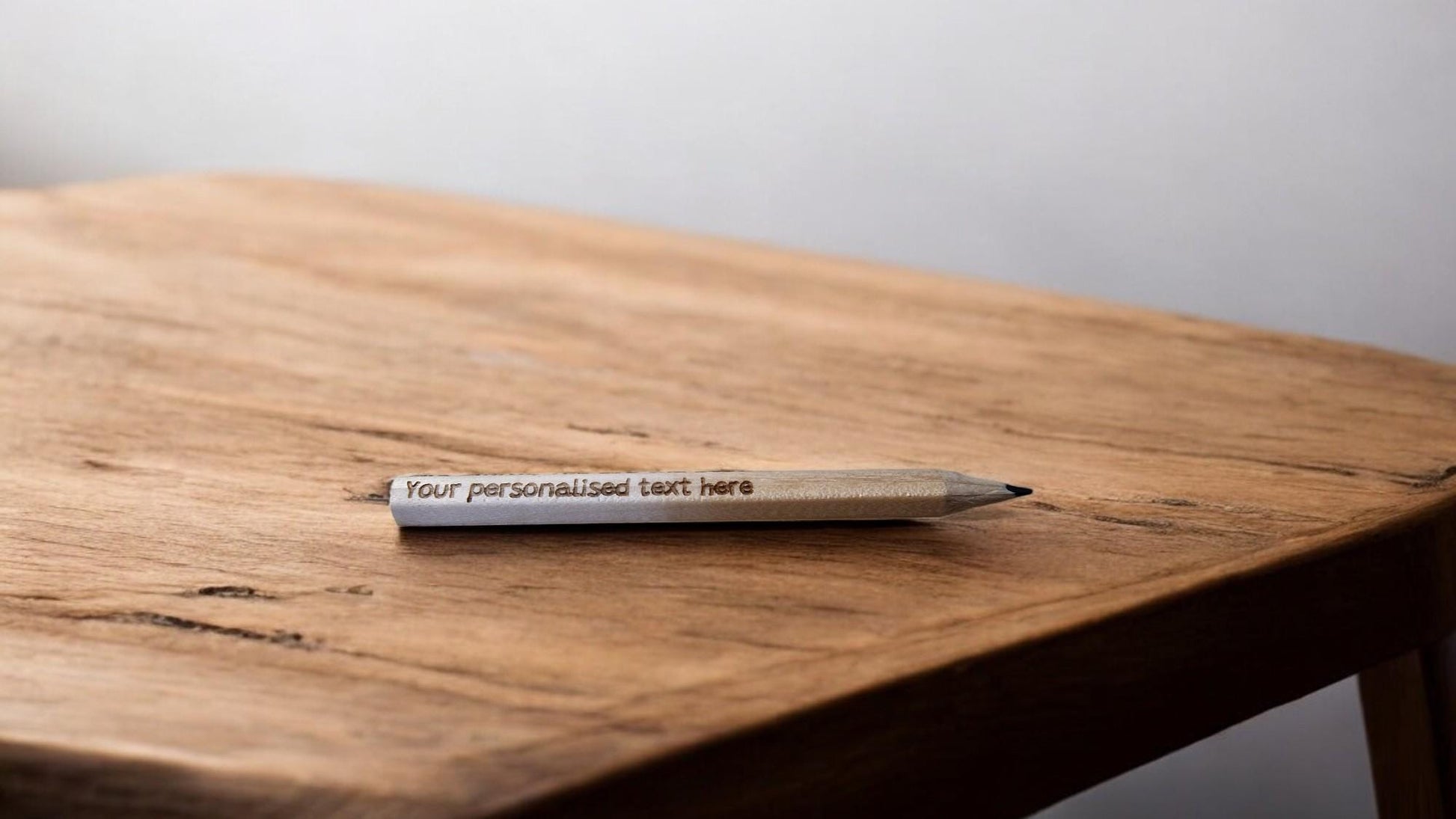 Set of 10 personalised mini wooden pencils with custom engraving, eco-friendly and packed in a matching engraved box—ideal for memorials, gifts, or office favours.