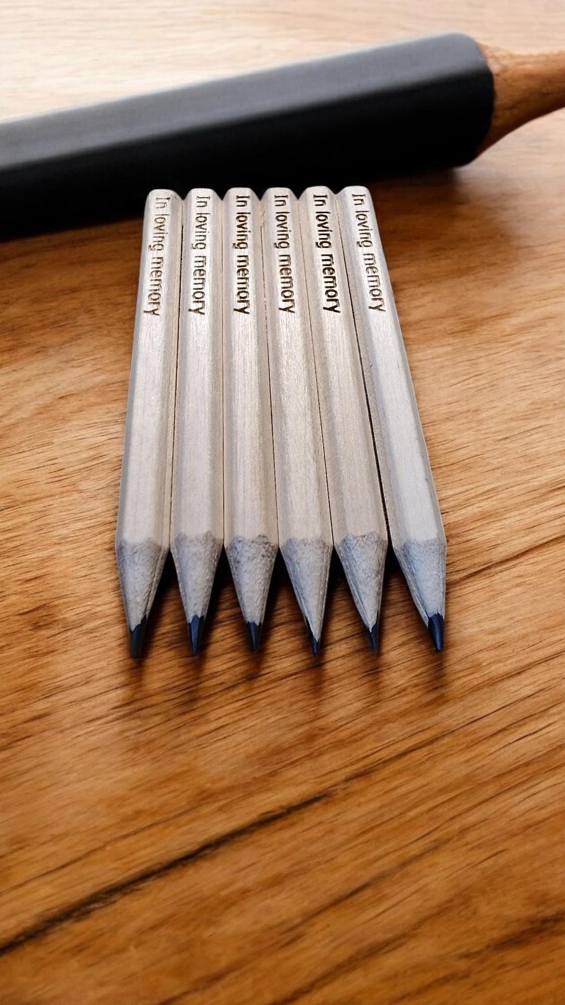 Set of 10 personalised mini wooden pencils with custom engraving, eco-friendly and packed in a matching engraved box—ideal for memorials, gifts, or office favours.