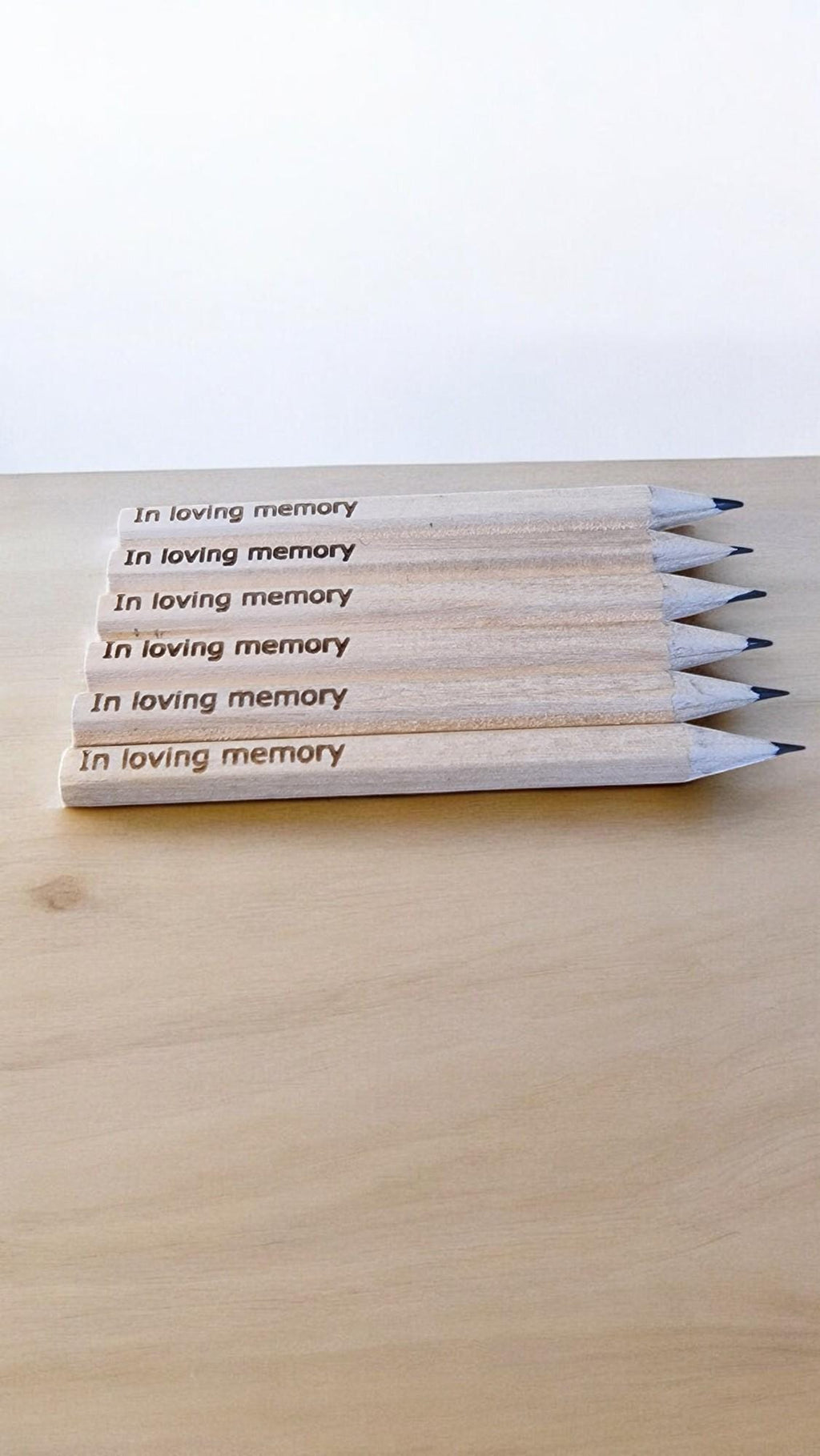 Set of 10 personalised mini wooden pencils with custom engraving, eco-friendly and packed in a matching engraved box—ideal for memorials, gifts, or office favours.