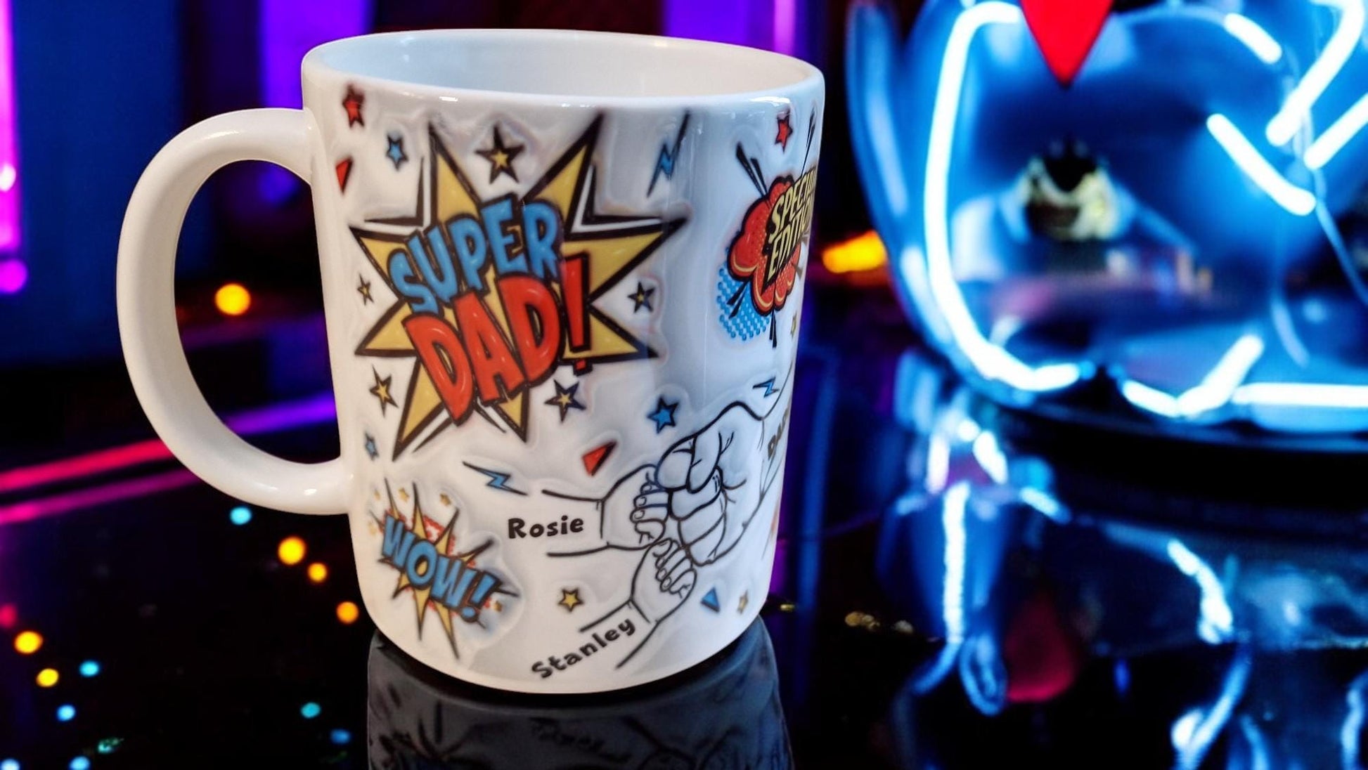 White ceramic mug with comic book “Super Dad!” and “Special Edition” graphics, plus a fist-bump illustration personalised with kids’ names