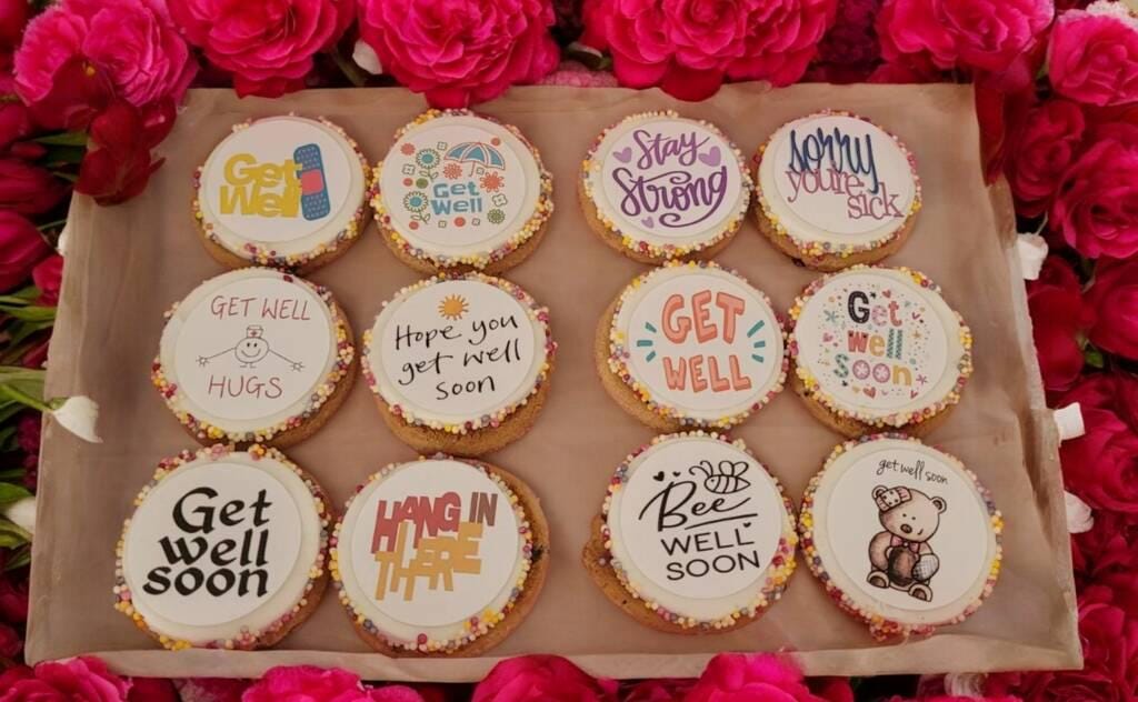 Box of personalised chocolate chip cookies with colourful edible toppers and sprinkles – get well soon pick me up gift