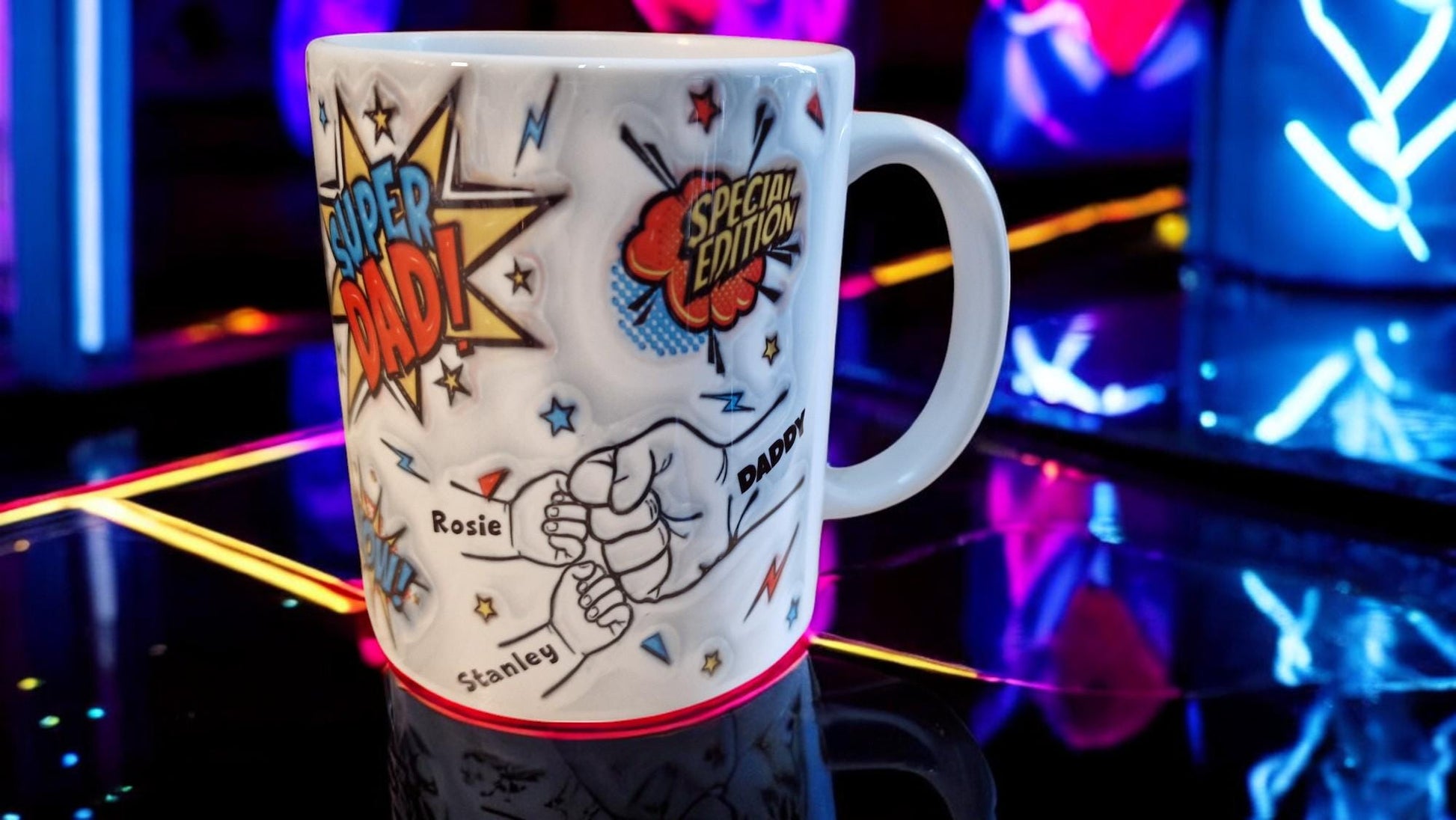 White ceramic mug with comic book “Super Dad!” and “Special Edition” graphics, plus a fist-bump illustration personalised with kids’ names