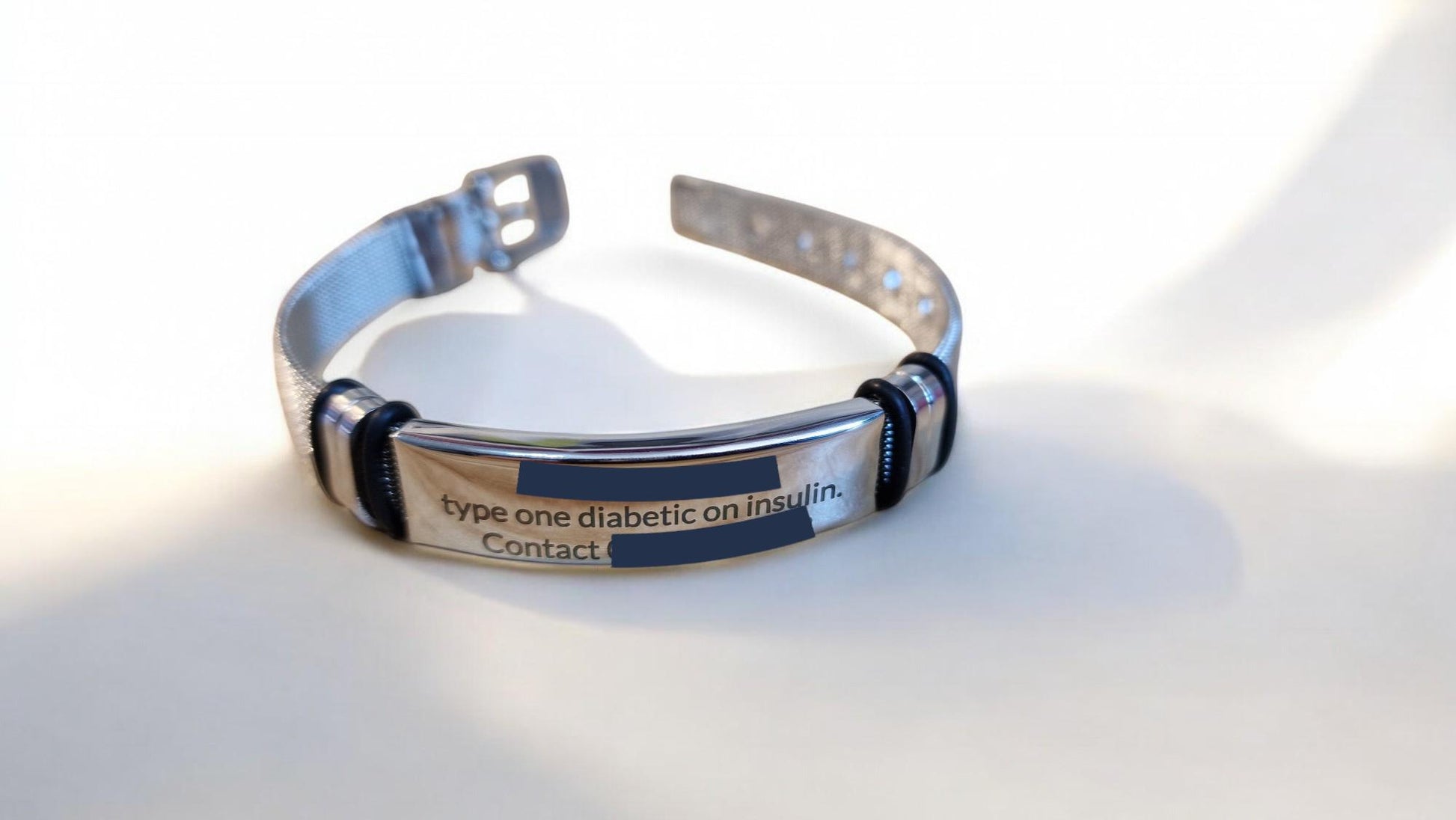 Personalised engraved medical ID steel bracelet in black or silver, adjustable mesh design for men or women, ideal for health and safety emergencies.