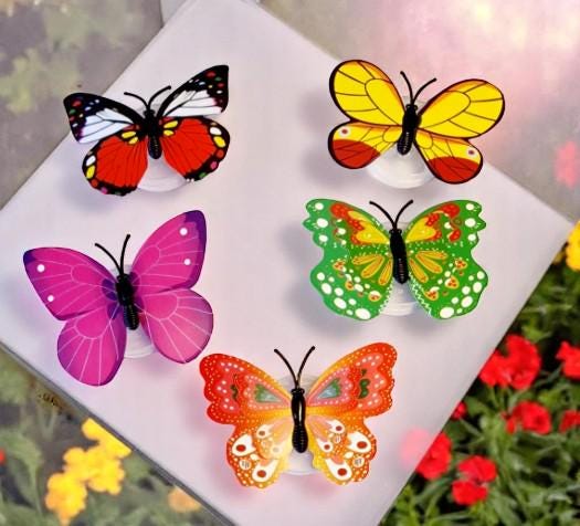 Set of five colourful butterfly LED night lights flashing on a wall, shown as fun party and room decor.