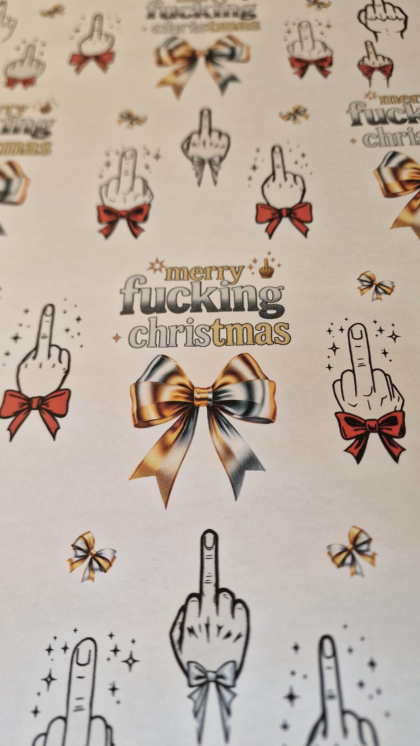 Two sheets of Merry Fucking Christmas wrapping paper with a cheeky middle finger design, displayed as funny Secret Santa gift wrap.