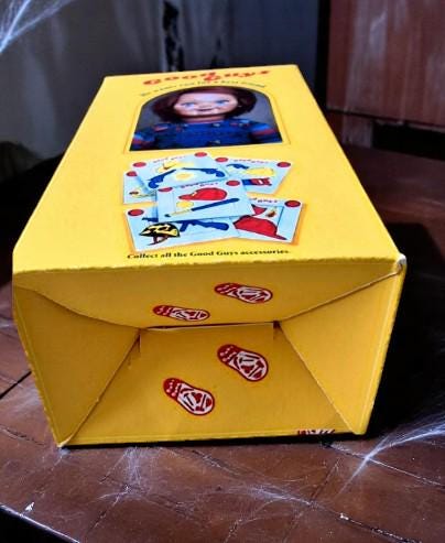 Chucky-themed socks in a Good Guys box with vegan edible cake toppers – perfect horror movie Halloween gift