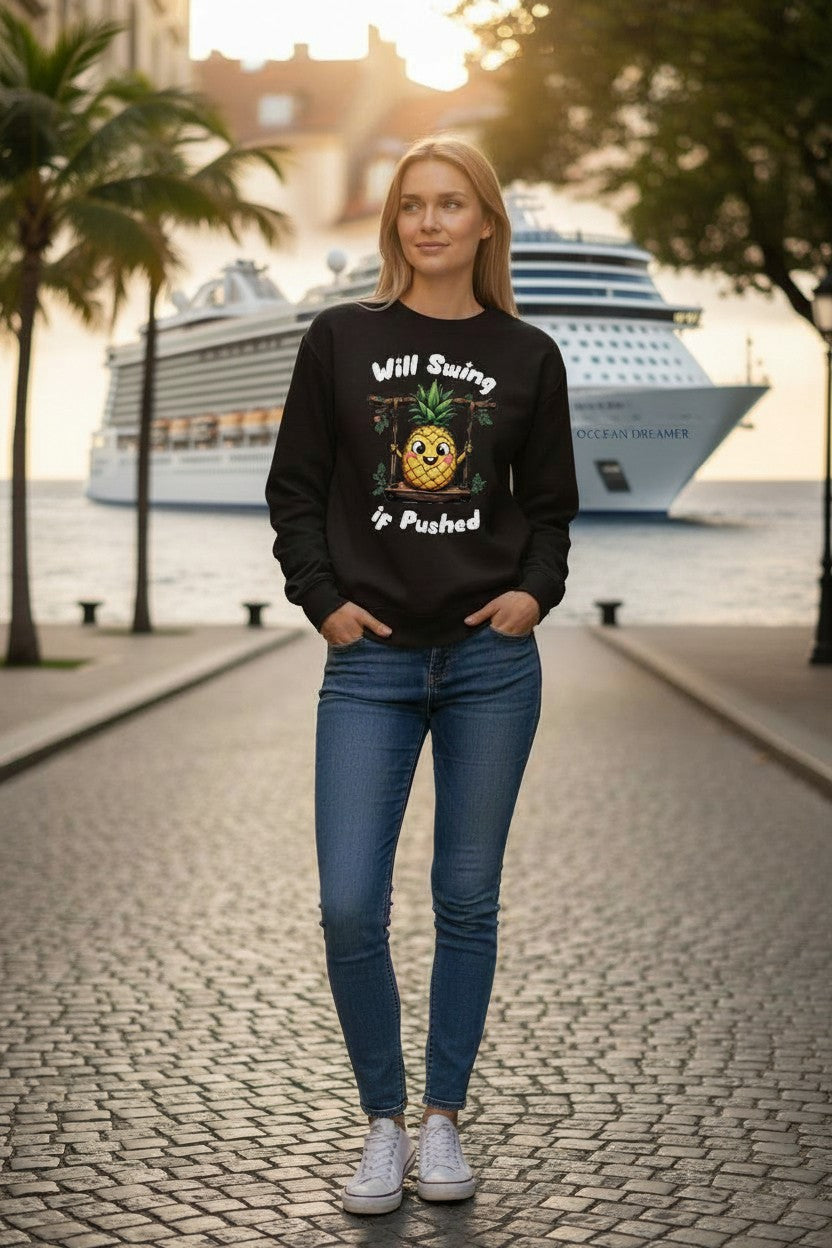 Person wearing a black sweatshirt with text and graphics, standing on a street with palm trees and a cruise ship in the background.