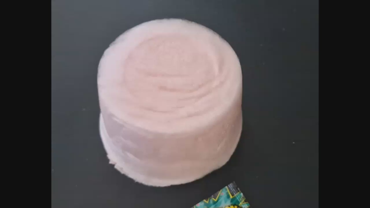 Blue raspberry candy pop with packaging on a white surface