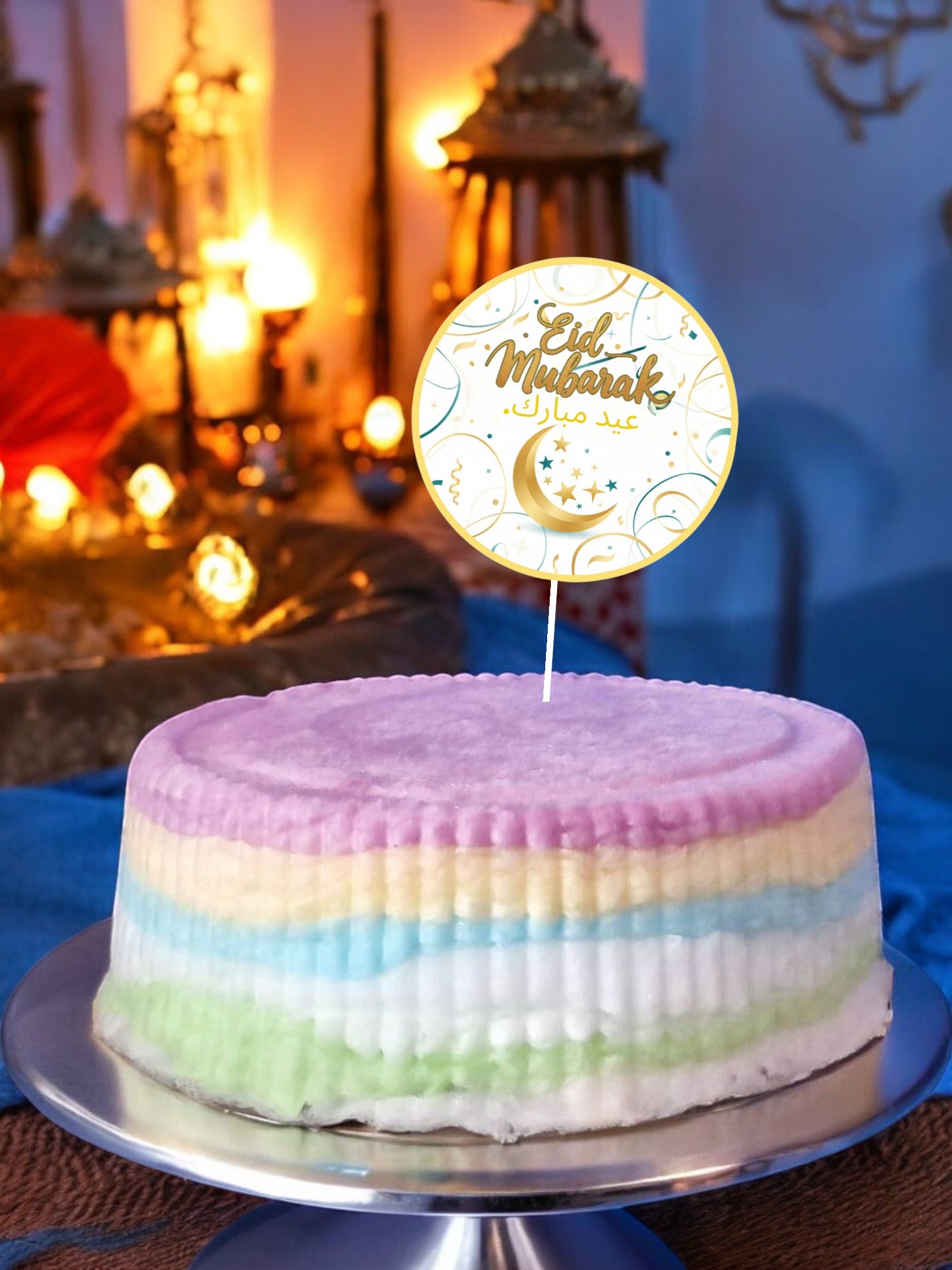 Pastel-colored cake with 'Ed Mubarak' topper on a decorative background