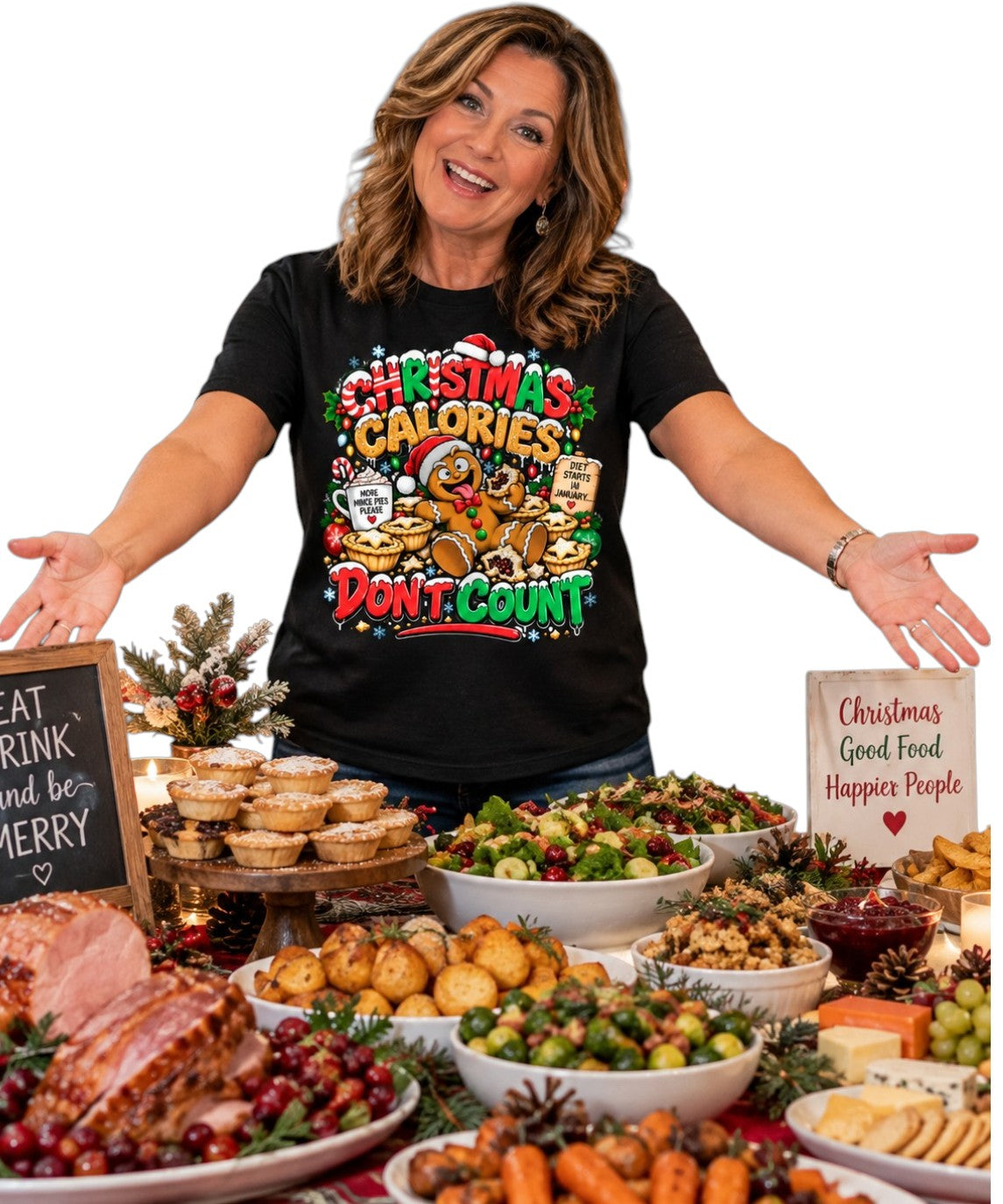 A woman stands behind a holiday food spread wearing a black graphic T-shirt with the text 'Christmas Calories Don't Count' and festive illustrations. The table is filled with roasted ham, salads, potatoes, crackers, and other Christmas dishes on a white studio background.