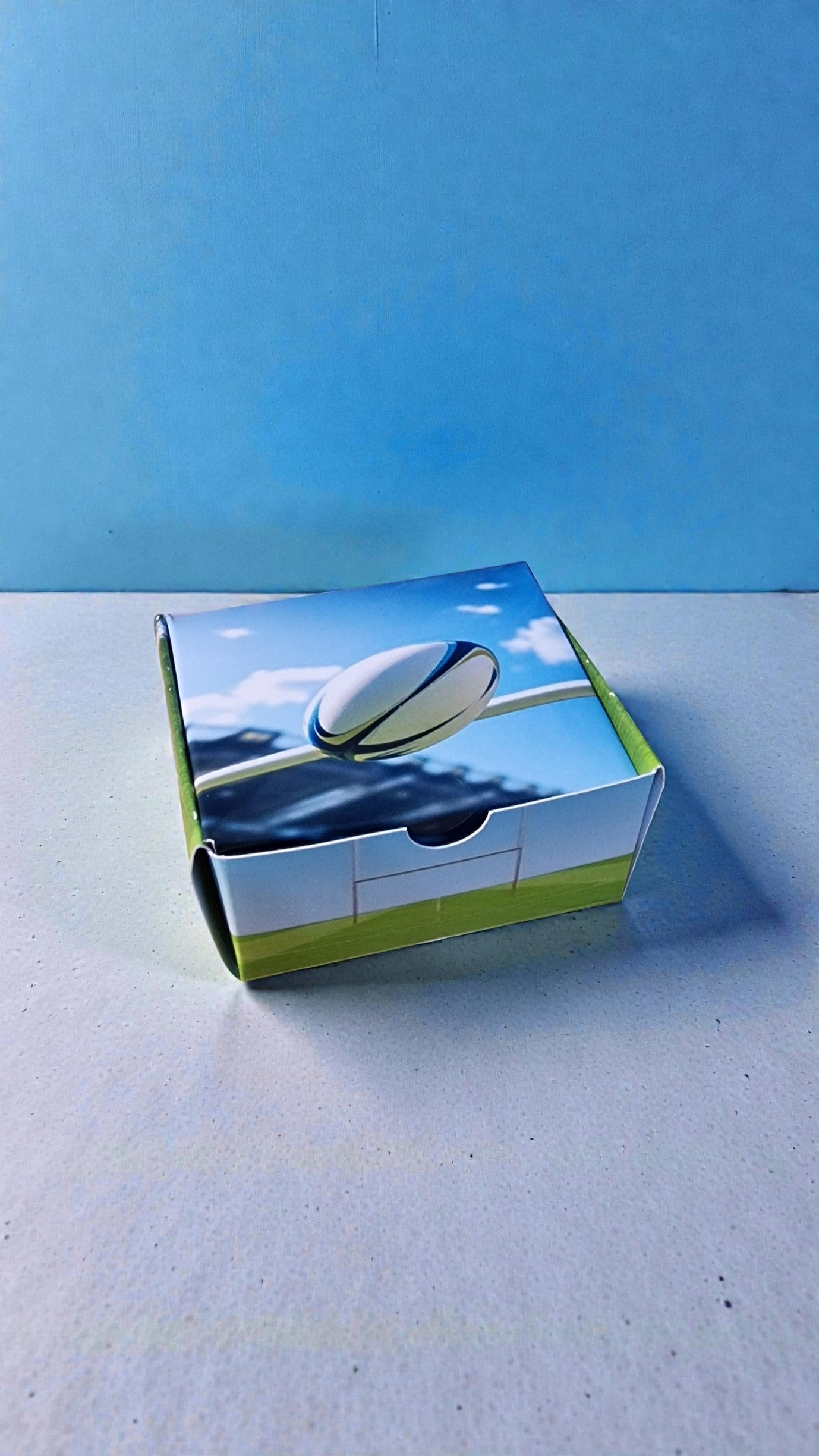 Product packaging with a blue sky and white cloud design on a light gray surface.