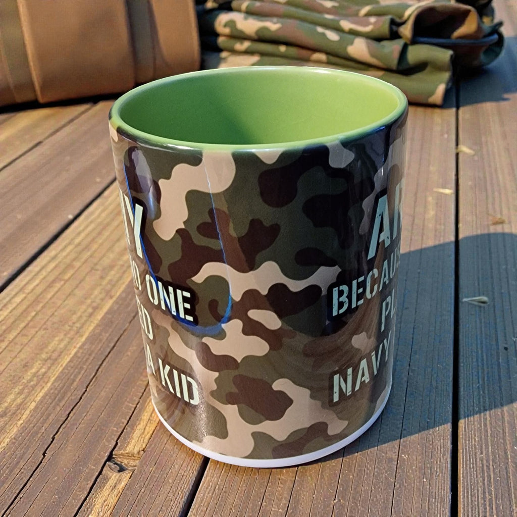 Camouflage-patterned mug with text on a wooden surface