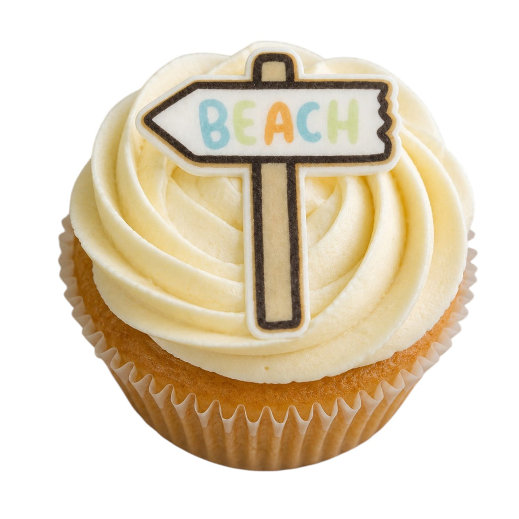 A frosted cupcake with swirls of pale cream icing and a small sign-shaped topper that reads “BEACH” in multicolored letters, shown on a plain white background.