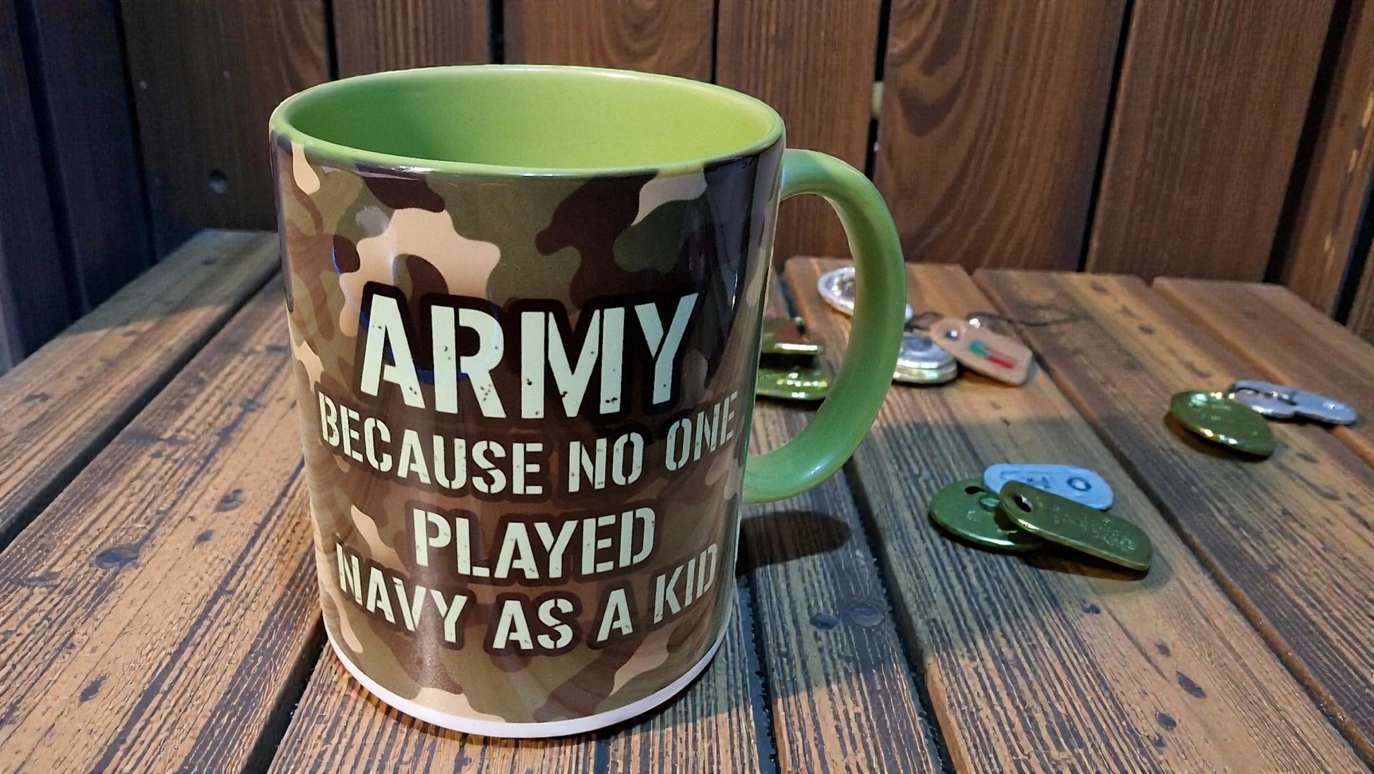 Camouflage mug with text on a wooden table