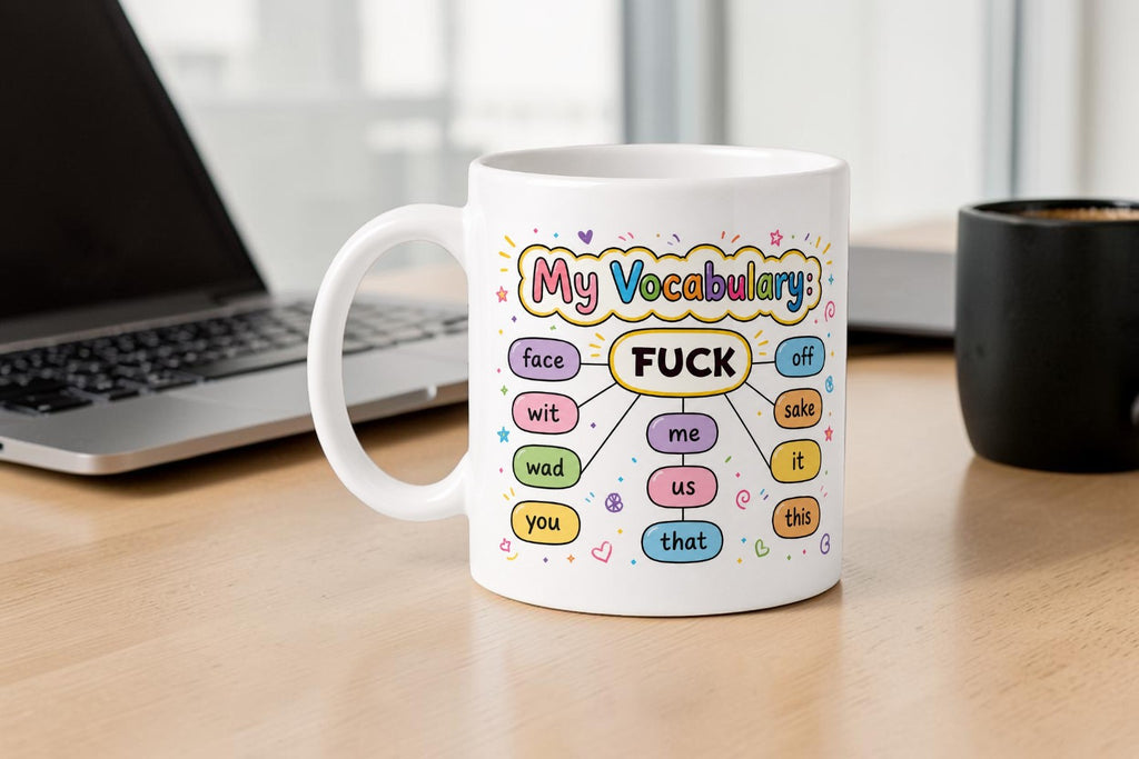Mug with colorful vocabulary diagram on a desk next to a laptop