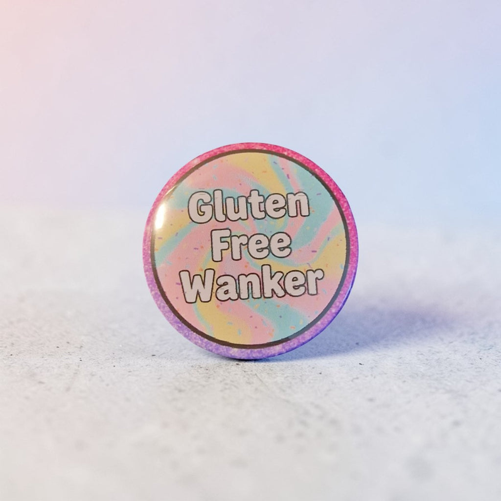 Round button badge with 'Gluten Free Wanker' text on a pastel rainbow gradient background.