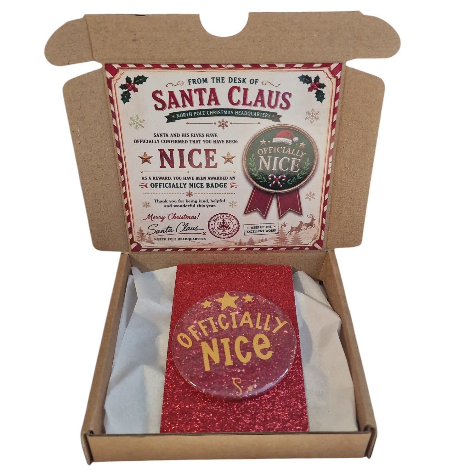 Box containing a 'From the Desk of Santa Claus' badge and card with a 'Officially Nice' badge.