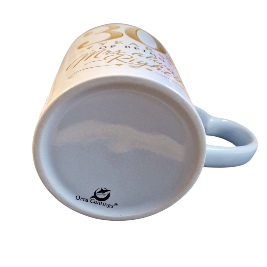 White mug with text and a blue handle on a white background