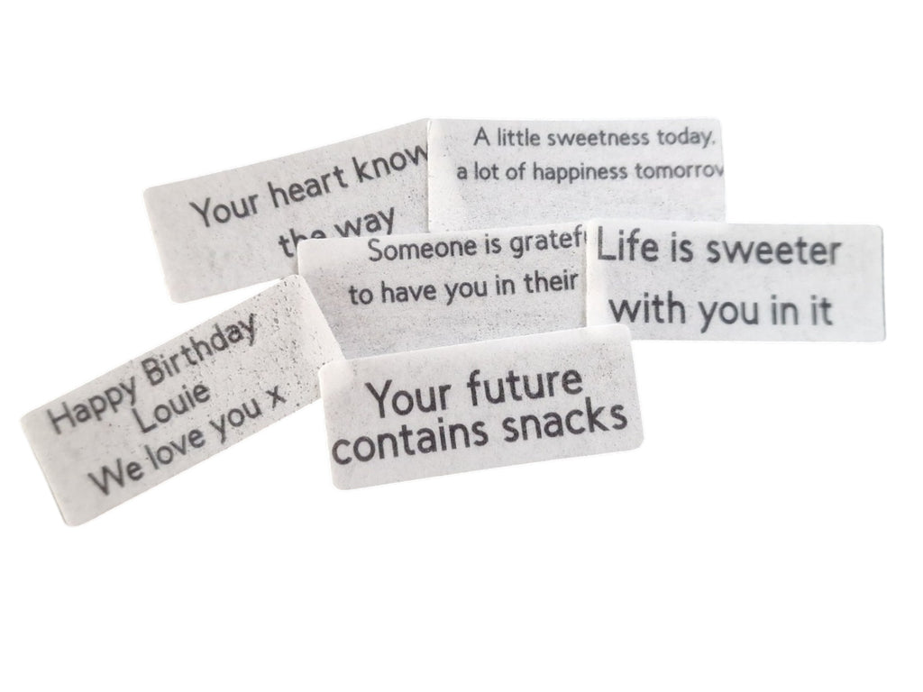 Set of small rectangular cards with printed messages on a white background