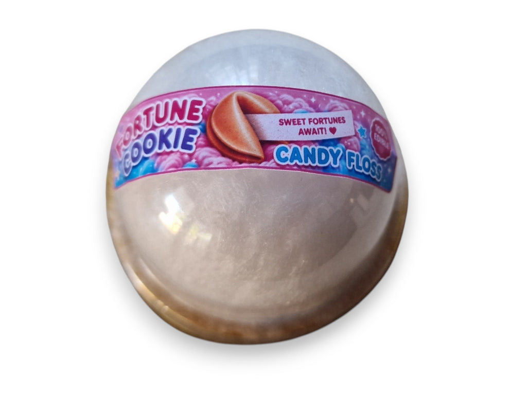 Fortune cookie-shaped candy with a pink label on a white background