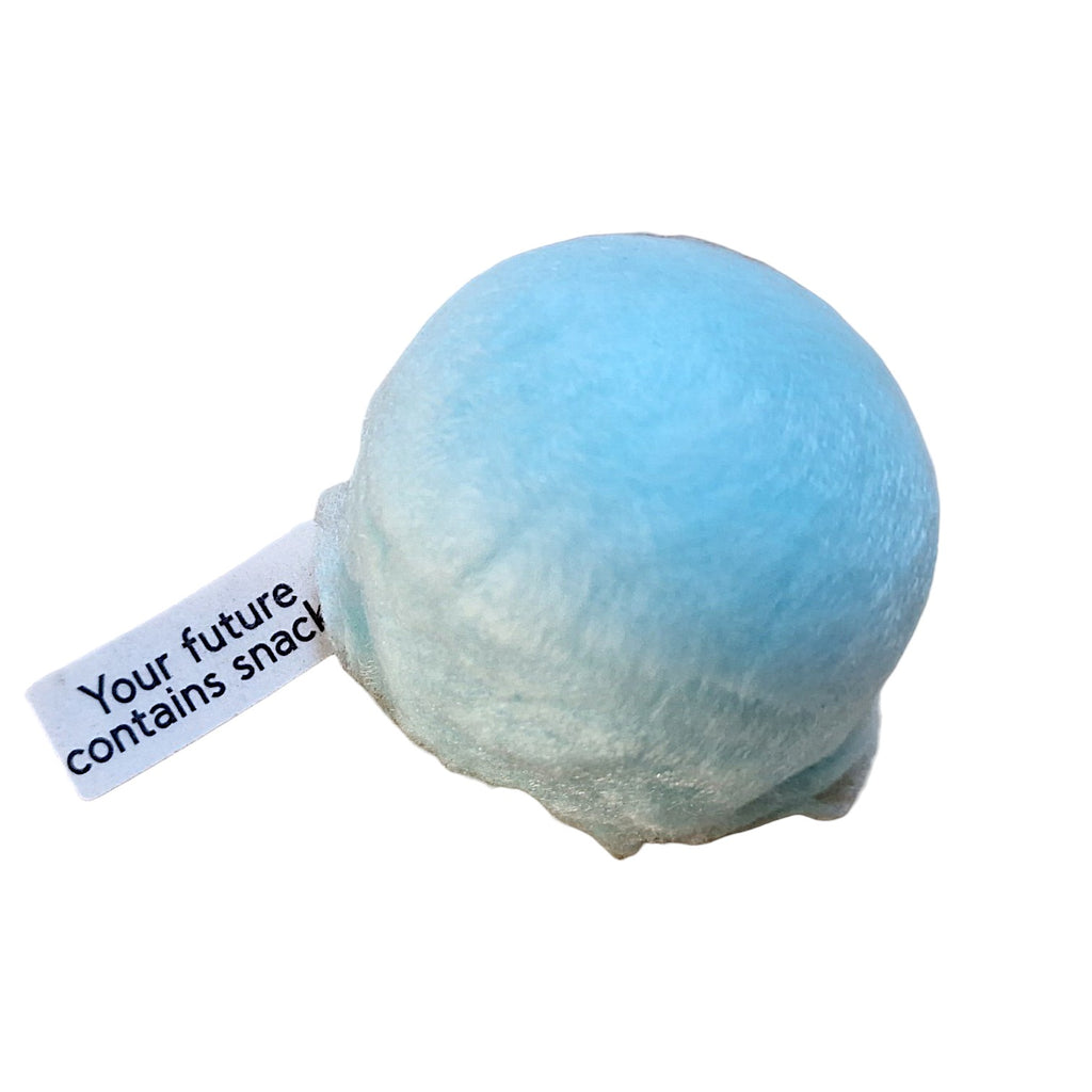 Light blue cotton ball with a tag saying 'Your future contains snack' on a white background