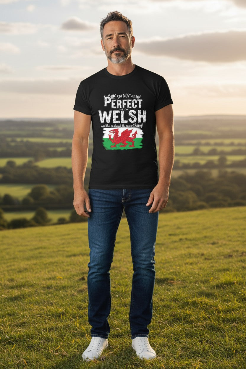 Man wearing a black t-shirt with Welsh design in a field