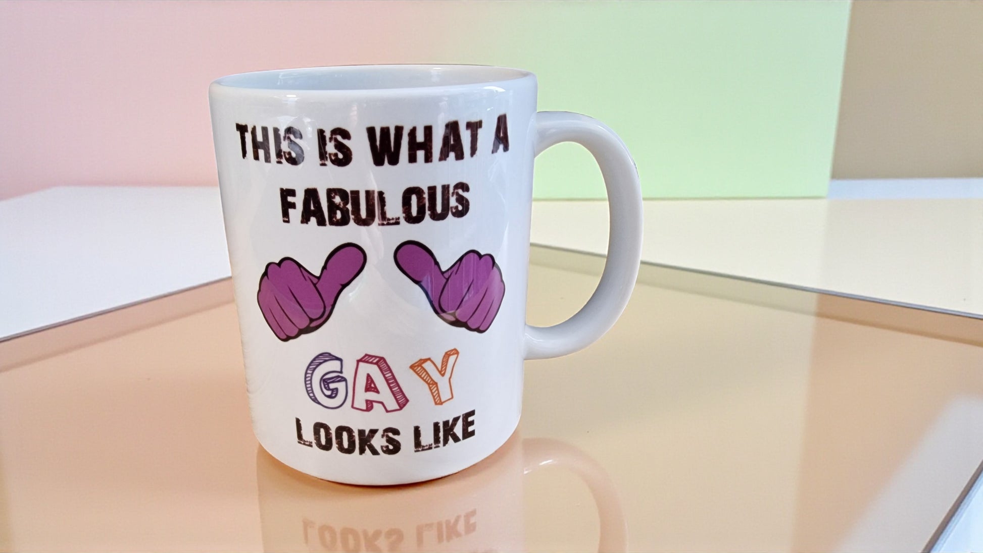 Mug with text and colorful letters on a reflective surface