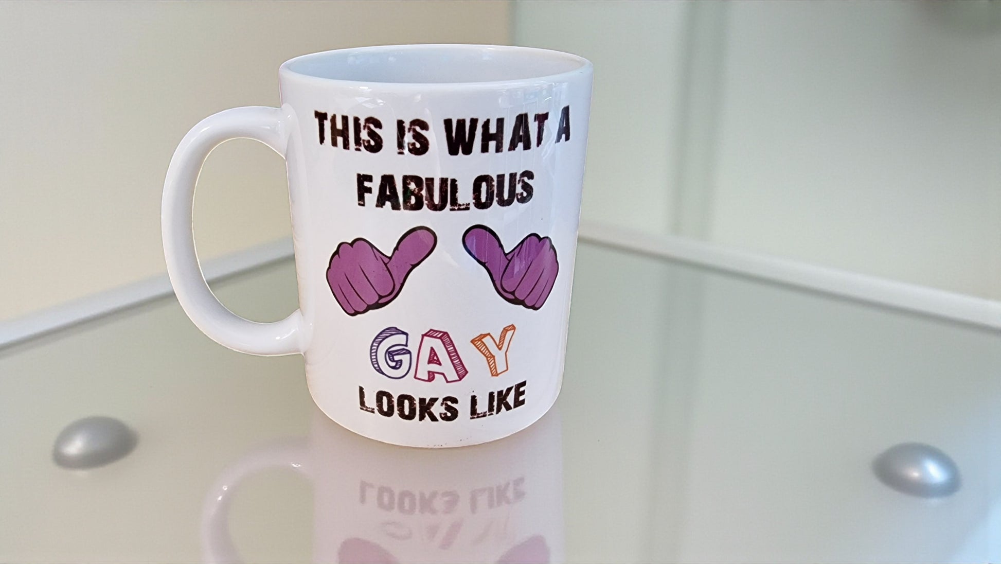 Mug with text and hand gesture symbols on a glass surface