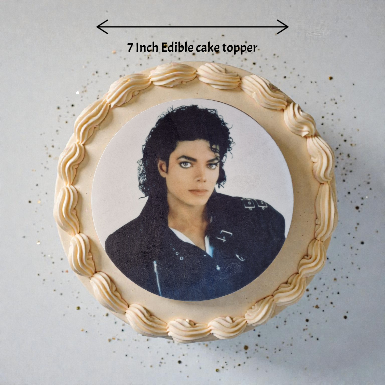 Edible cake topper with a portrait of a famous person on a decorative plate.