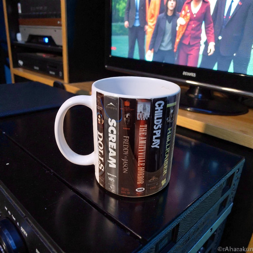 Mug with movie title design on a entertainment console with a TV in the background
